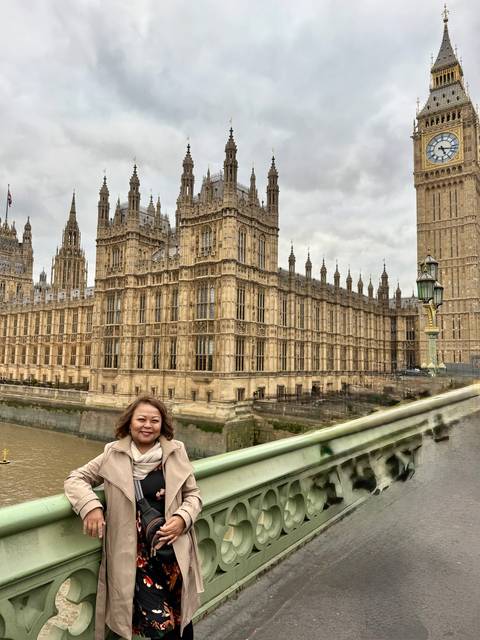 Person with the Houses of Parliament in the background.