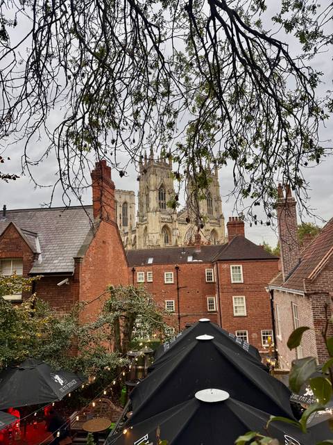 View of a cathedral behind residential buildings.