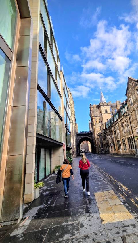       Stone buildings on a narrow street with a visible archway.
  