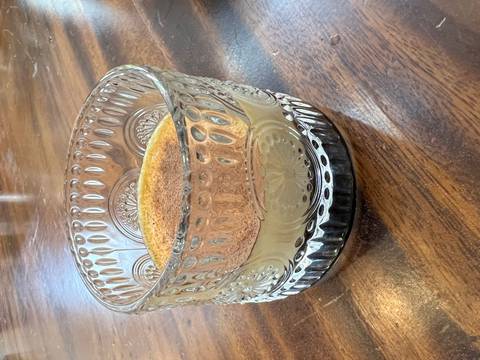 Close-up of a glass with a drink on a wooden table.