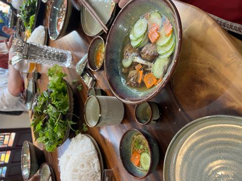 Table setting with traditional Vietnamese dishes.