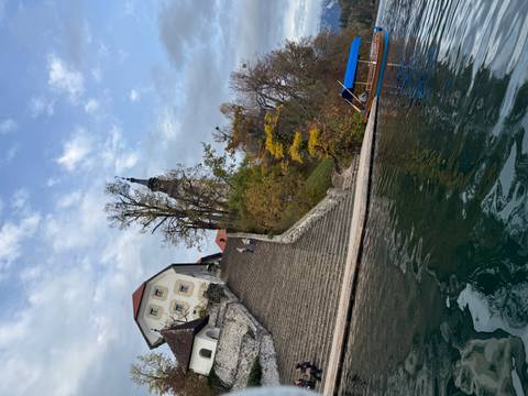       View of a staircase leading to a church with boats on the water.
  