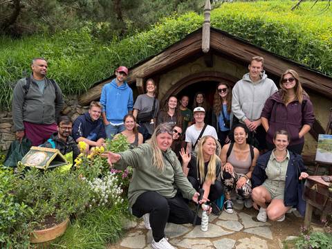       Group of people outside a Hobbit house.
  