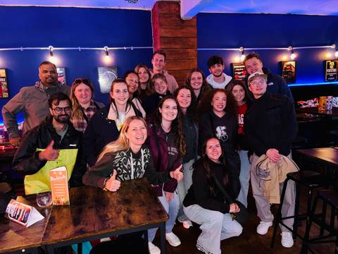       Group of people enjoying a night out at a bar.
  