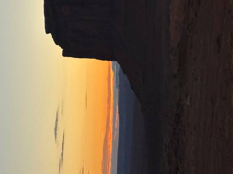       Silhouette of rock formations at sunset.
  