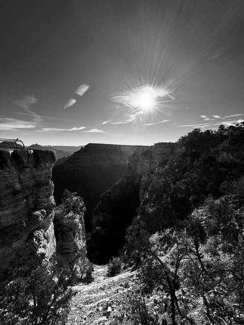       Grand Canyon with sun rays over the rim and cliffs.
  