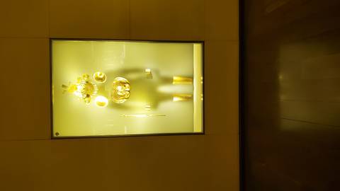       A display of gold artifacts in a museum setting.
  