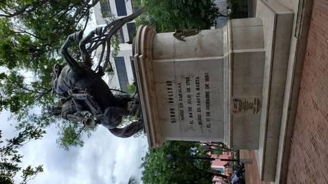       Statue of Simon Bolivar on a horse in a park setting.
  