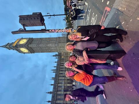 Group of people posing in front of Big Ben in London.