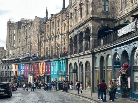 Colorful street with people, likely in Edinburgh.