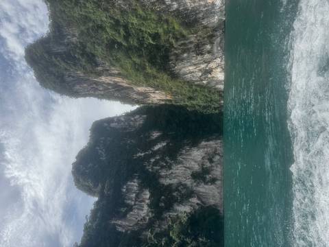       Scenic view of towering cliffs beside a body of water.
  