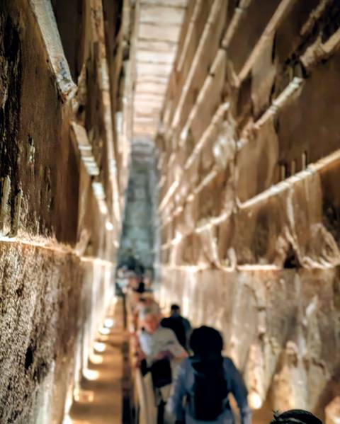Blurred image of an ancient stone corridor.