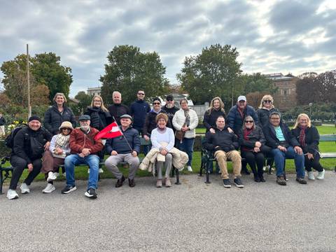 A group of people posing in a park setting.