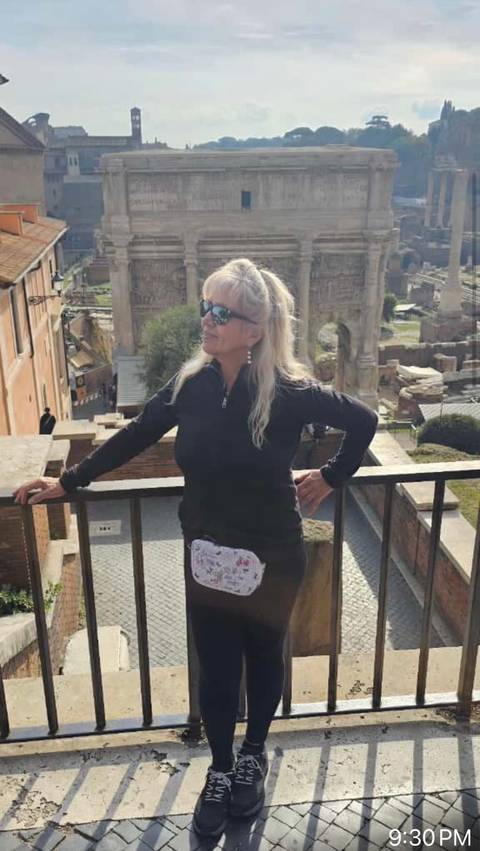 Woman posing near ancient ruins.