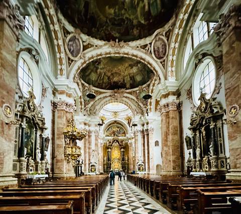 Interior view of an ornately decorated church ceiling.