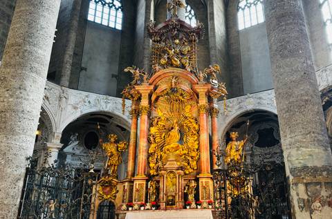 Elaborate and ornate church altar with golden statues.