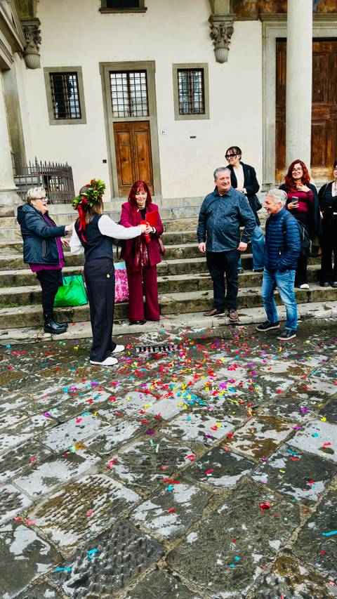 People walking on wet steps with colorful confetti.