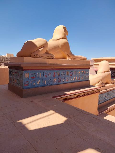 A structure with hieroglyphics in a desert setting.