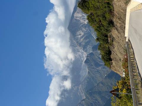Mountain road with clouds covering the mountain tops.