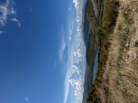 Hills, lakes, and a bright blue sky with clouds.