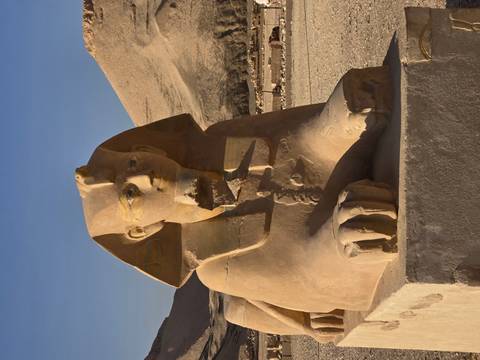 Sphinx statue with desert backdrop.