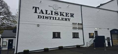 Exterior of Talisker Distillery building with signage.