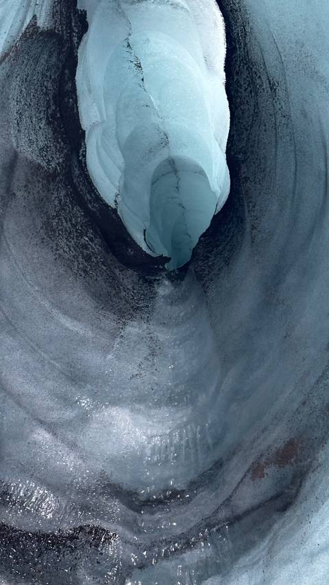 Deep ice cave with a narrow passageway.