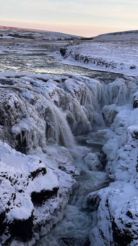       Frozen waterfall with intricate ice formations.
  