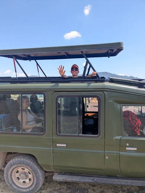 Tourists in a safari vehicle on a wildlife tour.