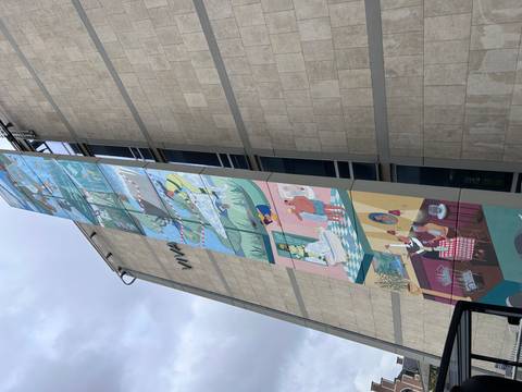 Tall building with a colorful mural.