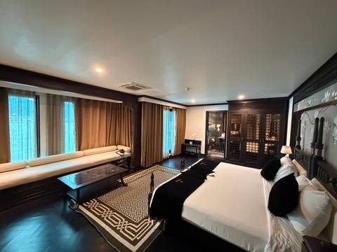       Luxury hotel room with modern decor and large windows.
  