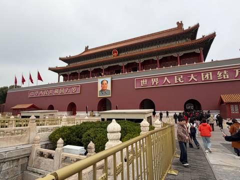 A large entrance with political red banners and a portrait of Mao Zedong.