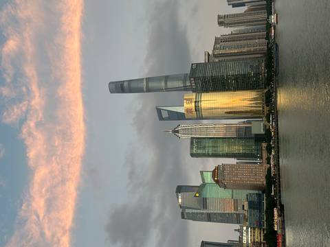 Skyline of Shanghai including the Oriental Pearl Tower at sunset.
