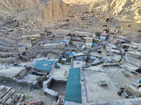 Aerial view of a rustic village in a mountainous area.