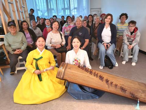 Group of people with traditional Korean musicians.