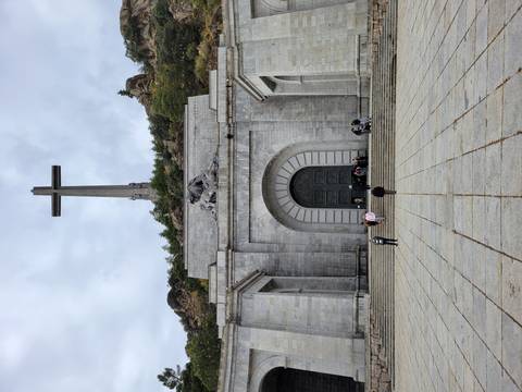 Massive cross monument with people in front.