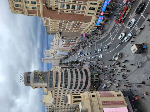 Busy city street with iconic building.