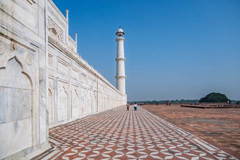 Side view of the Taj Mahal with a marble path and minaret.