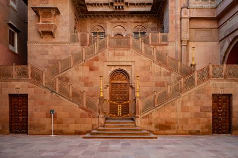 Elegant stairway leading to an ornate wooden door.