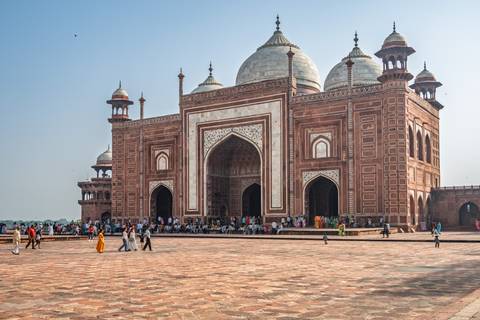 A grand mosque with multiple domes and open courtyard.