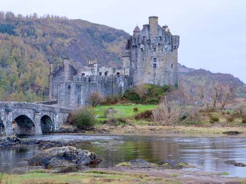 Eilean Donan Castle set against a mountainous backdrop.
