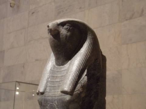 Ancient statue of a deity with a bird head.