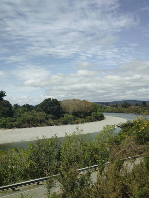 River bending with forest and hills in the background.