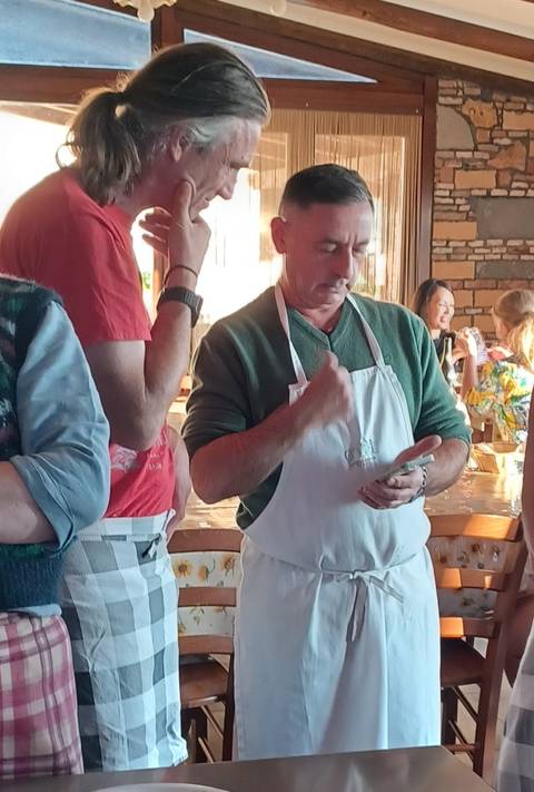 Indoor gathering with people in aprons.