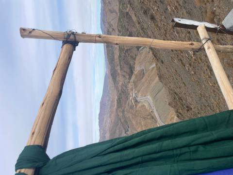       Mountain view seen through a wooden frame.
  
