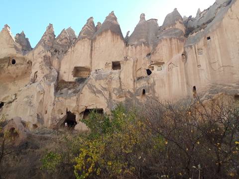 Cave dwellings carved into a rocky cliffside.