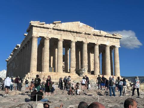 The Parthenon on the Acropolis with tourists around.
