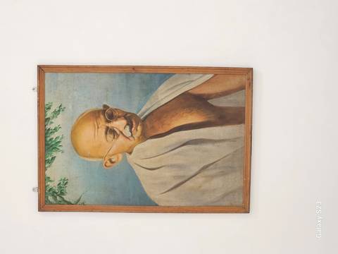 Portrait of Mahatma Gandhi in a frame.