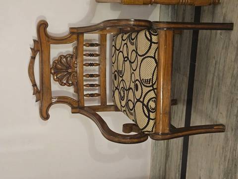       Ornate wooden chair with intricate design.
  