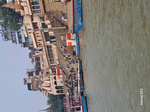View of a riverside with people and boats.